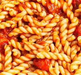 Wall Mural - Close-up view of delicious cooked pasta in tomato sauce, epitomizing italian cuisine.