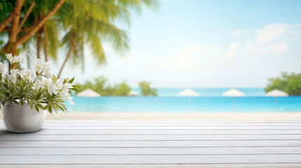 Wall Mural - White flowers are sitting on a wooden table overlooking a blurred beach with palm trees and white beach umbrellas