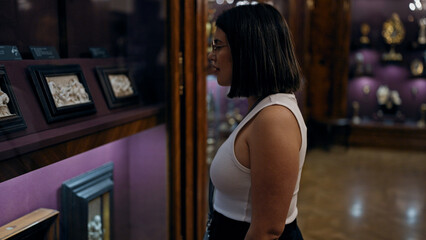 Wall Mural - Young beautiful hispanic woman looking at art exhibition at imperial treasure museum in Vienna