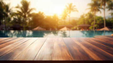 Wall Mural - Empty wooden tabletop perfect for displaying your product against a backdrop of a tranquil tropical resort pool at sunset