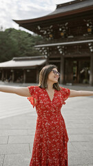 Poster - Beautiful hispanic woman joyfully embraces freedom, smiling with open arms, looking around meiji temple