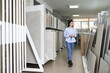© Serhii - female interior designer choosing flooring tile color texture samples at store shop
