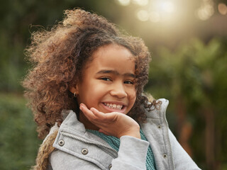 Black girl, child and backyard in portrait with smile for vacation, outdoor or winter in New York City. Female person, happiness and travel in Central Park with freedom for youth, holiday for relax