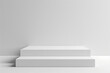 © Vovmar - White empty podium against a white wall. Two rectangular steps in the form of a podium, stages for product presentation.