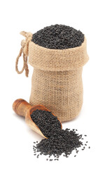 Wall Mural - Close-up of Organic Black Sesame (Sesamum indicum) Seeds, in a jute bag and on a scoop, Isolated on a white background.