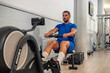 © EDER - athlete trains cardio and resistance with rowing machine in gym