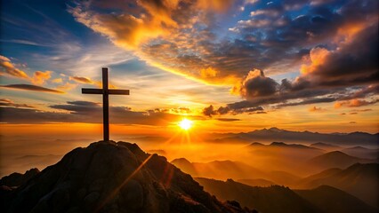 Silhouetted christian cross silhouette on the mountain at sunset