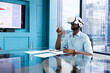 © Wavebreak Media - Using VR headset, businessman interacting with virtual interface in modern office, copy space