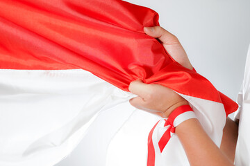 Excited men holding flags celebrating Indonesia's independence day