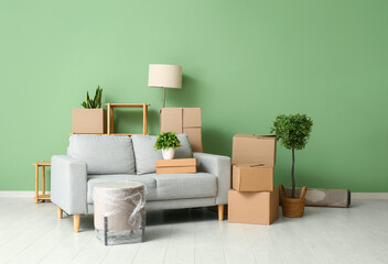 Poster - Cardboard boxes with sofa and plants in living room on moving day