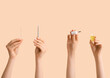© Pixel-Shot - Female hands with bottle of cuticle oil, pusher and orange stick on beige background