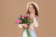 © Pixel-Shot - Beautiful young woman with roses talking by mobile phone on brown background