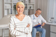 © Pixel-Shot - Mature woman after chemotherapy smiling in clinic