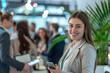 © Surachetsh - Close-up photo portrays the animated reactions of a group of businesswoman and participants as they laugh and listen attentively to startup business owner at trade show exhibition event.