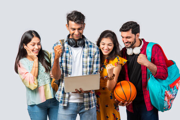 Wall Mural - Indian asian college students using laptop isolated against white background