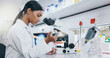 © CoetzeeRising/peopleimages.com - Woman, science and working with microscope in laboratory, microbiology and research study of organisms. Specimen, analysis and bacteria or antimicrobial resistance, medicine and vaccine development