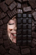 © Михаил Решетников - The face of a caucasian woman surrounded by sweets. The girl is smeared in chocolate.