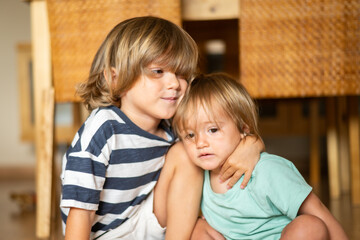 Wall Mural - Young brother and sister sharing a loving moment