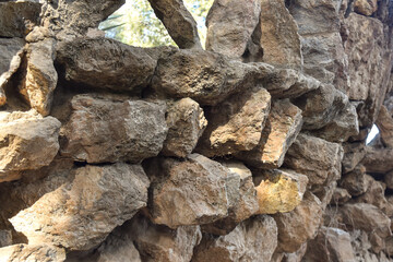 stone wall background with natural pattern and tree shadows