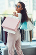 © NonVig/peopleimages.com - Retail, fashion and portrait of woman with shopping bags, happy and smile while in boutique. Face, clothes and girl customer excited for clothing sale, discount or outfit choice in New York store