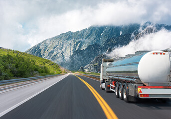 Wall Mural - Fuel truck on a picturesque road. A silver tank truck transports fuel.