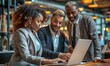© khwanchai - Business people standing meeting having a discussion and using a laptop