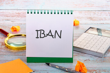 IBAN International Bank Account Number SWIFT Concept. IBAN in an upright notebook in a composition with office supplies