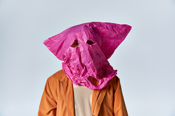 Sticker - A man wearing a pink plastic bag as a mask.