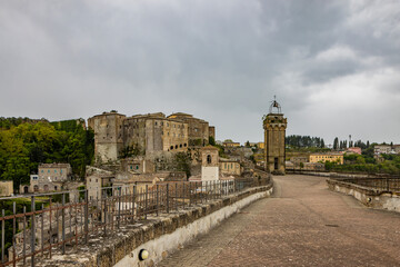 Wall Mural - A glimpse of the ancient medieval village of Sorano, on a melancholy and rainy spring day. In the province of Grosseto, Tuscany, Italy. The old houses built in stone and tuff bricks.