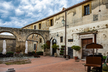 Wall Mural - A glimpse of the ancient medieval village of Sorano, on a melancholy and rainy spring day. In the province of Grosseto, Tuscany, Italy. The old houses built in stone and tuff bricks.