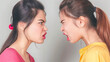© Anna - Two young women yelling at each other in a heated argument, facial expressions showing anger. Conflict resolution, communication skills, emotional expression, interpersonal relationships.