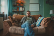 © wernerimages - young man sitting on sofa and looking depressed