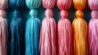© Hassan - a group of multicolored tassels hanging on a wall.