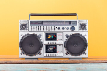 Wall Mural - Retro boombox radio cassette recorder from 1980s front yellow background. Vintage old style filtered photo