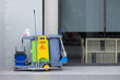 © Rattanachat - A cleaning cart with a yellow sign on it