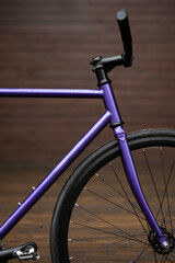 Purple city bike on the street. Fixsd gear culture