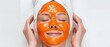 © Gasi - Young woman with papaya facial mask isolated on white background, skincare concept.