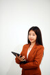 © Sirikarn Rinruesee - Young beautiful Asian woman in business office standing use tablet in hand, Thai girl enjoy browsing for online shopping store with copy space for advertisement, on isolated white background
