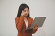 © Sirikarn Rinruesee - Young beautiful Asian woman in business office standing use tablet in hand, Thai girl enjoy browsing for online shopping store with copy space for advertisement, on isolated white background