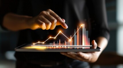 Aufkleber - A close-up of hands holding a tablet displaying a business growth graph with upward trends.