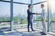 © AK Coop/peopleimages.com - Handshake, meeting and business men in office with welcome for thank you, greeting or introduction. Partnership, commercial realtor and client shaking hands for agreement, b2b deal or acquisition