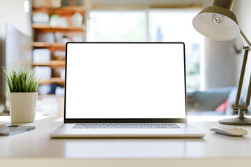 Wall Mural - laptop with a blank screen on a table in a bright home office. perfect for inserting your own conten