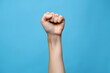 © Evan - Empowerment: Raised Fist with Blue Background