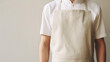 © DELstudio - Man wearing beige linen apron mock up in the modern kitchen, chef uniform for cooking