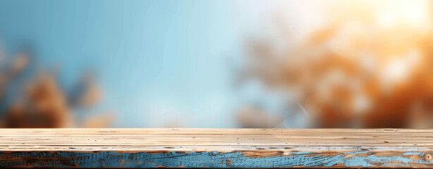 Wall Mural - Wooden Table Top on Light Blue and Brown Blurred Background for Product Display in E-commerce