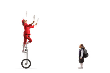 Poster - Schoolgirl watching an acrobat riding a unicycle and juggling