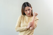 © Pormezz - young woman scratching on her arm and has a red rash irritation on her skin from dust intolerance.