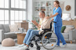 © Pixel-Shot - Senior man suffering from Parkinson syndrome in wheelchair with nurse at home