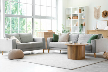 Sticker - Interior of light living room with grey sofas, shelf unit and plants