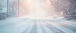 © filmanana - Snowy winter street with falling snow and illuminated streetlights in blizzard conditions